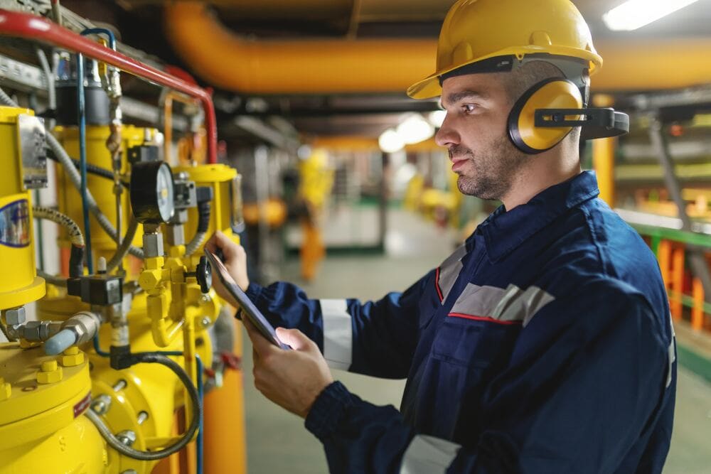 Operator using a handheld breaker on site — workplace noise and vibration assessment